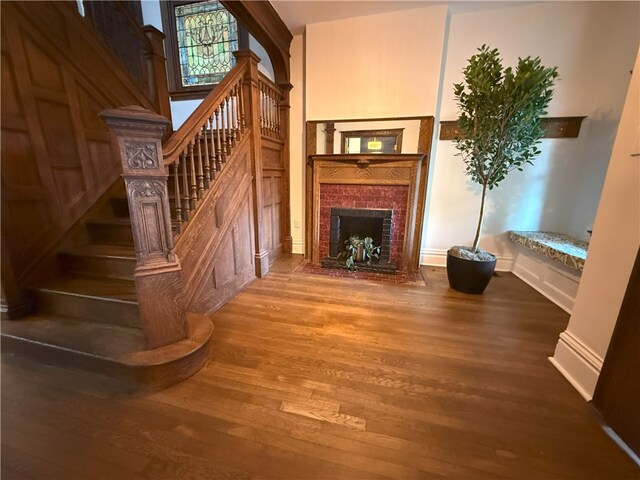 715 Chislett, East Liberty, PA 15206 - unfurnished living room featuring wood finished floors, a fireplace, stairway, and baseboards
