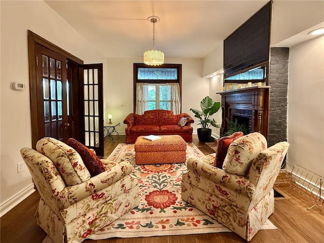 715 Chislett, East Liberty, PA 15206 - living area with baseboards, wood finished floors, and a brick fireplace