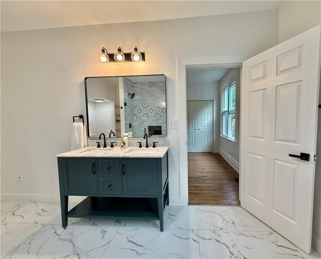 715 Chislett, East Liberty, PA 15206 - full bath with double vanity, baseboards, marble look tile flooring, and a shower