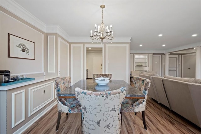 128 N Craig St Unit 415, Oakland, PA 15213 - dining room with wood finished floors, a chandelier, crown molding, recessed lighting, and a decorative wall