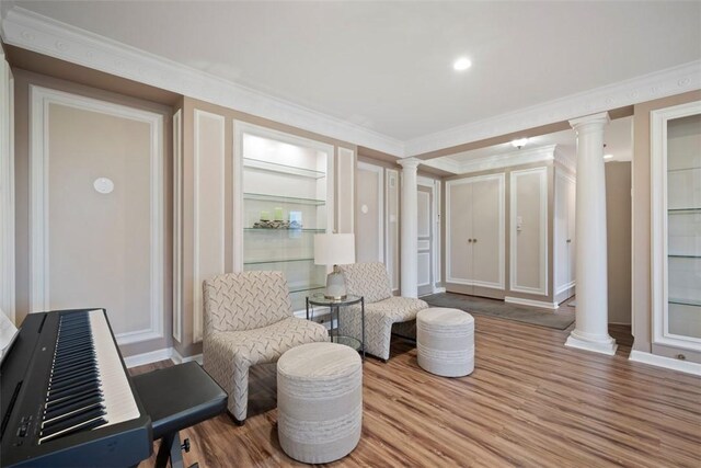 128 N Craig St Unit 415, Oakland, PA 15213 - living area featuring ornate columns, wood finished floors, crown molding, and baseboards