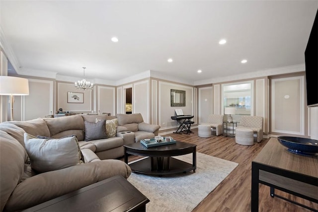 128 N Craig St Unit 415, Oakland, PA 15213 - living room featuring crown molding, wood finished floors, a chandelier, a decorative wall, and recessed lighting