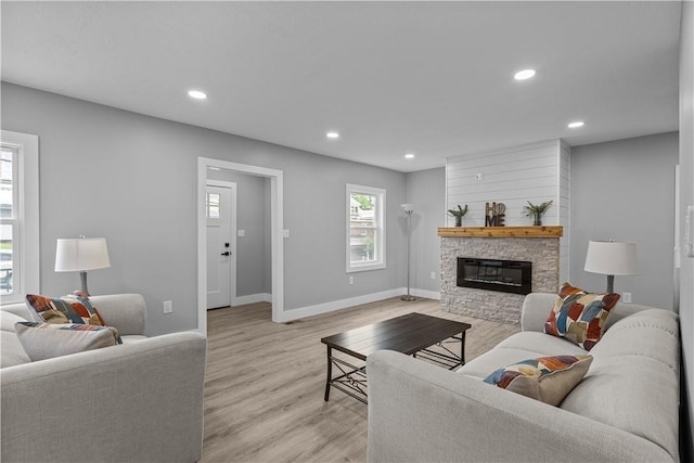 421 W College St, Canonsburg, PA 15317 - living area featuring baseboards, recessed lighting, a stone fireplace, and light wood finished floors