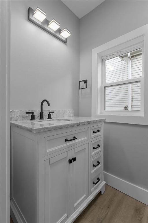 421 W College St, Canonsburg, PA 15317 - bathroom featuring wood finished floors, vanity, and baseboards