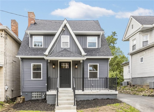 421 W College St, Canonsburg, PA 15317 - view of front of house with covered porch, board and batten siding, a shingled roof, and central air condition unit