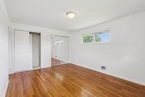 200 Edgewood Dr, Hopewell Twp Bea, PA 15001 - unfurnished bedroom with multiple closets, wood finished floors, and baseboards