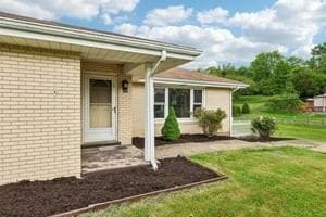 200 Edgewood Dr, Hopewell Twp Bea, PA 15001 - property entrance featuring brick siding and a yard