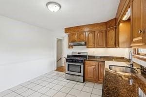 200 Edgewood Dr, Hopewell Twp Bea, PA 15001 - kitchen featuring stainless steel gas range, under cabinet range hood, brown cabinets, a sink, and light tile patterned flooring