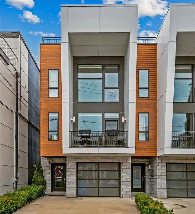 4707 Hatfield St, Lawrenceville, PA 15201 - view of building exterior featuring an attached garage and driveway