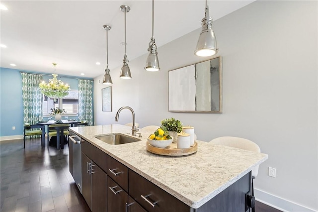 4707 Hatfield St, Lawrenceville, PA 15201 - kitchen with dark brown cabinets, dark wood-style flooring, a kitchen island with sink, a chandelier, and hanging light fixtures