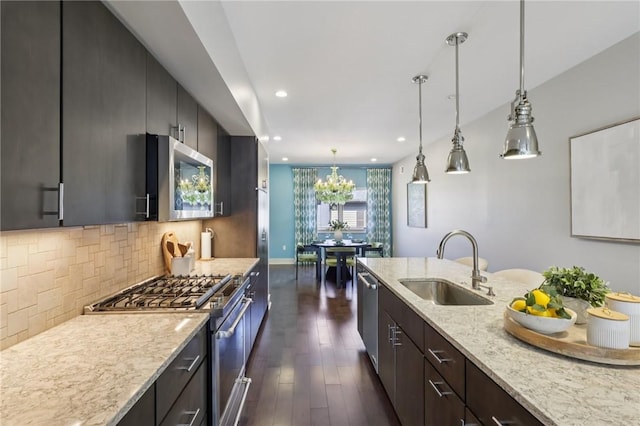 4707 Hatfield St, Lawrenceville, PA 15201 - kitchen with appliances with stainless steel finishes, dark wood-style flooring, pendant lighting, backsplash, and recessed lighting