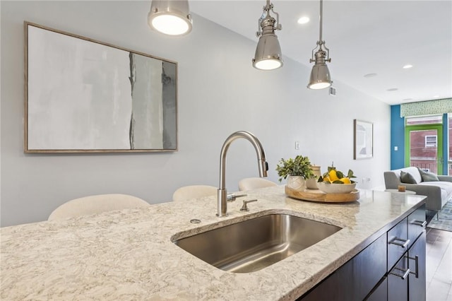 4707 Hatfield St, Lawrenceville, PA 15201 - kitchen with light stone countertops, hanging light fixtures, and open floor plan