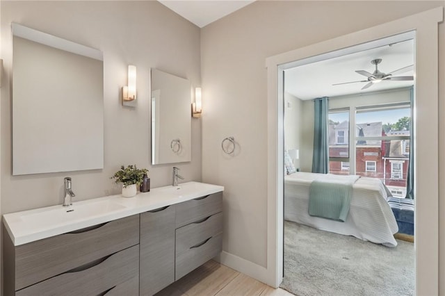 4707 Hatfield St, Lawrenceville, PA 15201 - bathroom featuring double vanity, ensuite bath, a ceiling fan, and wood finished floors