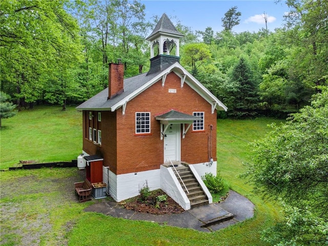 2554 Rte 259, Fairfield Twp, PA 15923 - view of front of property featuring brick siding, a chimney, a front yard, and a wooded view