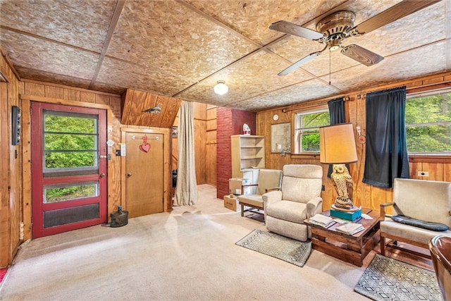 2554 Rte 259, Fairfield Twp, PA 15923 - living area with carpet floors, wood walls, and a ceiling fan