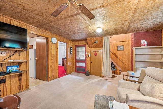 2554 Rte 259, Fairfield Twp, PA 15923 - sitting room featuring wood walls, carpet, ceiling fan, stairs, and an ornate ceiling