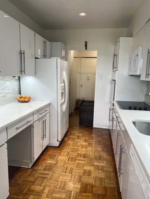 320 Fort Duquesne Blvd Unit 18F, Downtown Pgh, PA 15222 - kitchen with white appliances, light countertops, tasteful backsplash, white cabinets, and recessed lighting