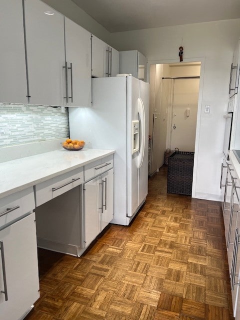 320 Fort Duquesne Blvd Unit 18F, Downtown Pgh, PA 15222 - kitchen with white fridge with ice dispenser, light countertops, backsplash, and white cabinets