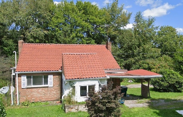 29564 Lake Creek Rd, Pa, PA 16314 - back of house with a chimney, a tiled roof, and a lawn