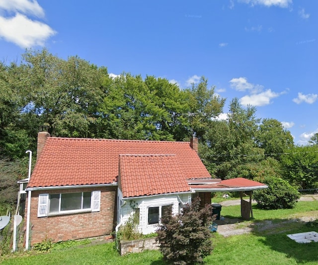 29564 Lake Creek Rd, Pa, PA 16314 - view of front of house featuring a chimney, a tiled roof, brick siding, and a front yard