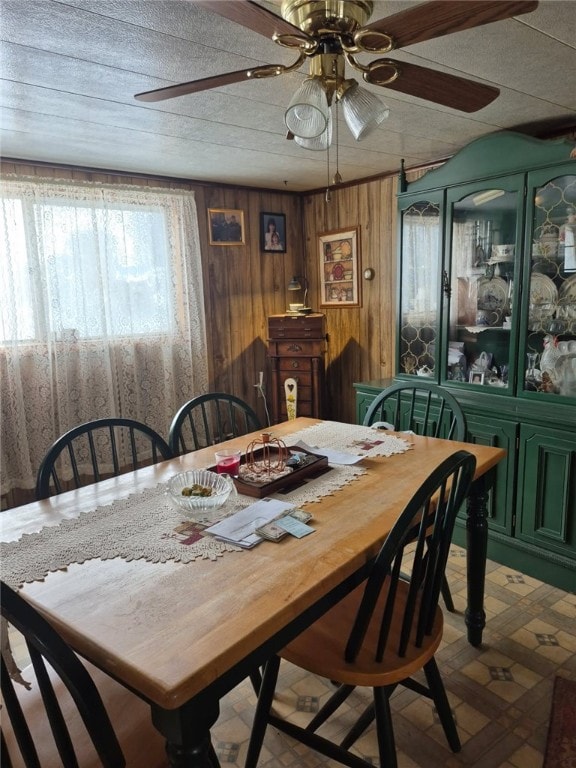 29564 Lake Creek Rd, Pa, PA 16314 - dining area with plenty of natural light, a ceiling fan, wooden walls, and tile patterned floors