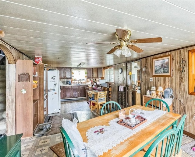 29564 Lake Creek Rd, Pa, PA 16314 - dining room with wooden walls, light floors, and ceiling fan