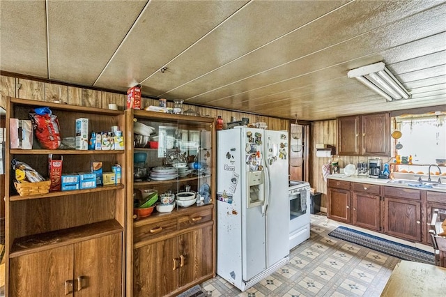 29564 Lake Creek Rd, Pa, PA 16314 - kitchen featuring white refrigerator with ice dispenser, a sink, range, light countertops, and light flooring