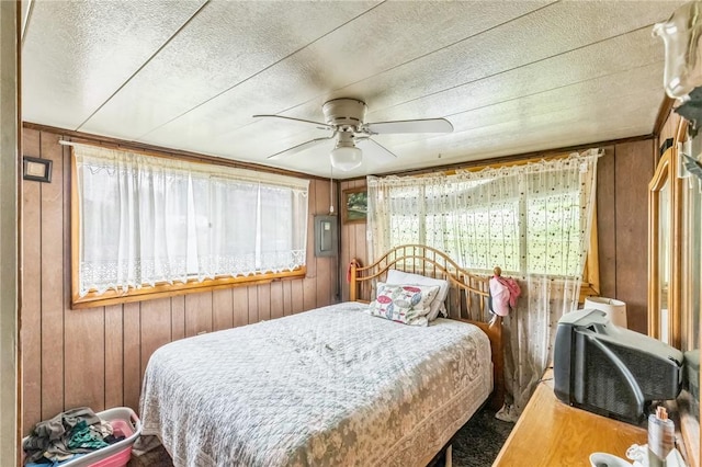 29564 Lake Creek Rd, Pa, PA 16314 - bedroom featuring wood walls, ceiling fan, and a textured ceiling