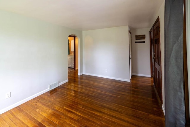 1153 Yanks Ln, South Park, PA 15236 - empty room featuring arched walkways, wood finished floors, and baseboards
