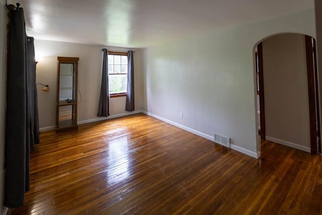 1153 Yanks Ln, South Park, PA 15236 - empty room featuring arched walkways, hardwood / wood-style floors, and baseboards
