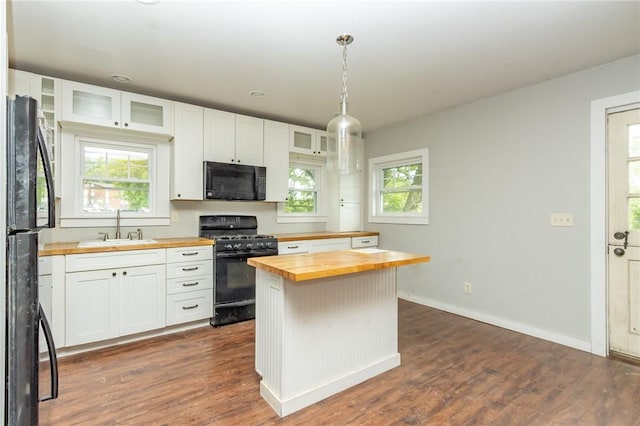 1017 Olive Ave, Natrona Hts/Harrison Twp, PA 15065 - kitchen with butcher block counters, black appliances, a sink, white cabinetry, and glass insert cabinets