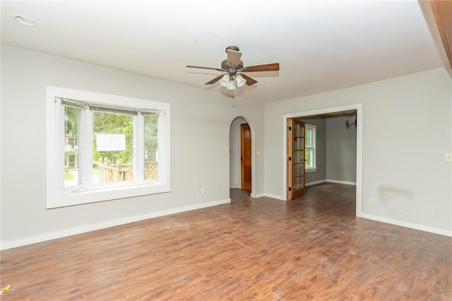 1017 Olive Ave, Natrona Hts/Harrison Twp, PA 15065 - spare room with healthy amount of natural light, arched walkways, baseboards, and wood finished floors