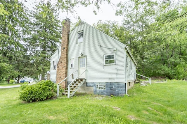 1017 Olive Ave, Natrona Hts/Harrison Twp, PA 15065 - back of property featuring a chimney, a lawn, and entry steps