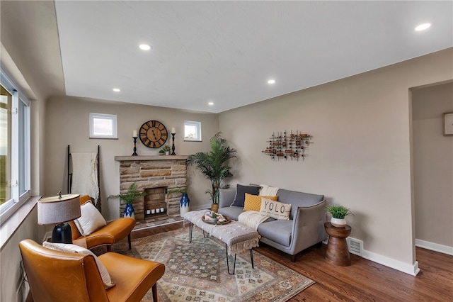 3815 Foster Rd N, Versailles, PA 15137 - living area featuring wood finished floors, recessed lighting, baseboards, and a stone fireplace