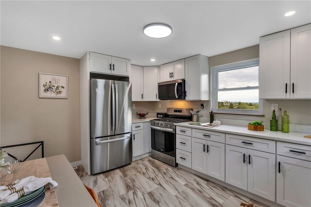 3815 Foster Rd N, Versailles, PA 15137 - kitchen with appliances with stainless steel finishes, white cabinetry, recessed lighting, and light marble finish floors