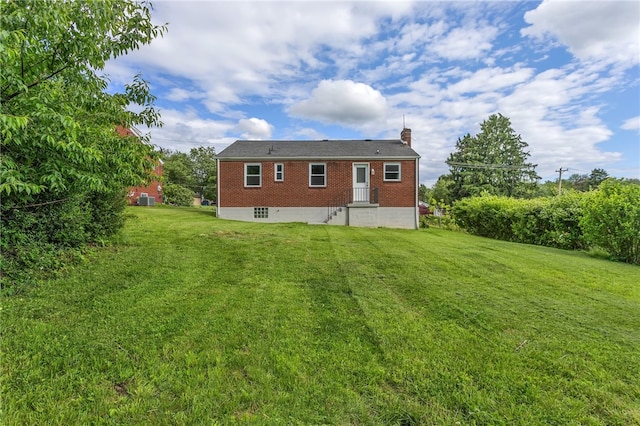 3815 Foster Rd N, Versailles, PA 15137 - rear view of house with a yard, brick siding, and a chimney