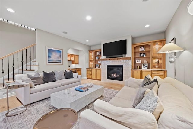 3602 Senate Ct, Adams Twp, PA 16059 - living room featuring light wood-type flooring, a glass covered fireplace, recessed lighting, stairs, and baseboards