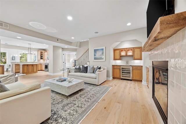 3602 Senate Ct, Adams Twp, PA 16059 - living area featuring wine cooler, light wood-style flooring, stairway, recessed lighting, and bar with sink