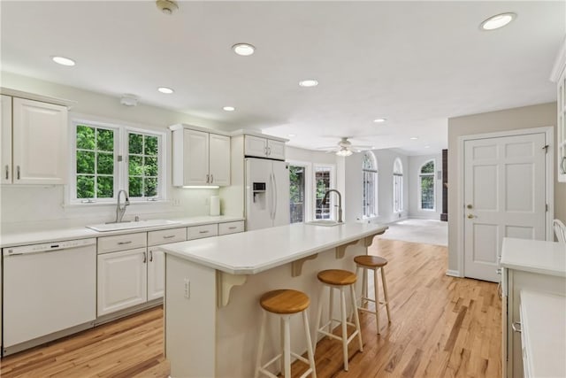 131 Hidden Valley Rd, Murrysville, PA 15146 - kitchen with white appliances, a sink, a kitchen bar, plenty of natural light, and recessed lighting