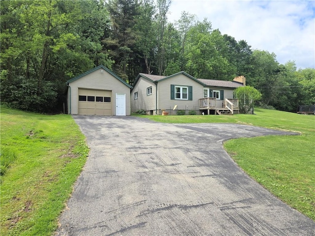 1126 Slate Point Rd, Parks Twp, PA 15690 - view of front of home with asphalt driveway, an outbuilding, a detached garage, a chimney, and a front lawn