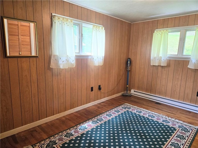 1126 Slate Point Rd, Parks Twp, PA 15690 - unfurnished room with plenty of natural light, dark wood-style floors, baseboards, a baseboard heating unit, and wooden walls