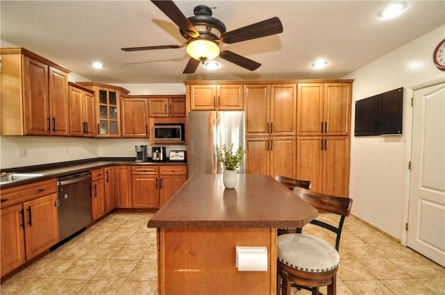 1726 Kennedy, Elizabeth Twp/Boro, PA 15018 - kitchen featuring stainless steel appliances, dark countertops, brown cabinetry, a kitchen bar, and a center island