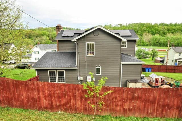1726 Kennedy, Elizabeth Twp/Boro, PA 15018 - rear view of house featuring roof mounted solar panels, a chimney, and a shingled roof