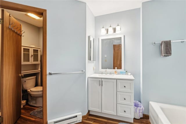 1630 Snowfield Way, Hidden Valley, PA 15502 - full bathroom with baseboard heating, toilet, vanity, wood finished floors, and a tub