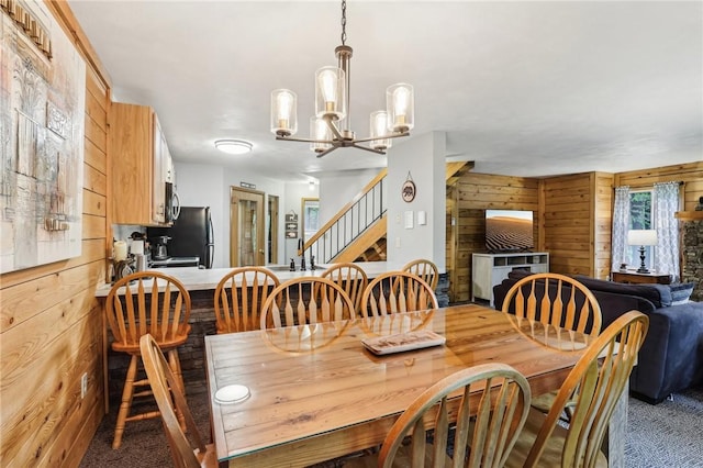 1630 Snowfield Way, Hidden Valley, PA 15502 - carpeted dining space with wood walls, a chandelier, and stairs