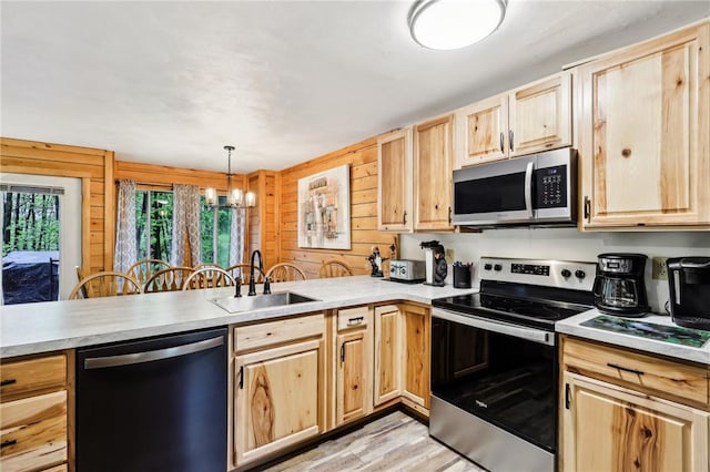 1630 Snowfield Way, Hidden Valley, PA 15502 - kitchen with appliances with stainless steel finishes, light brown cabinets, a sink, a chandelier, and a peninsula
