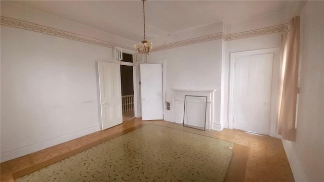 141 Mayflower St, Lincoln-Larimer, PA 15206 - empty room featuring a chandelier and baseboards