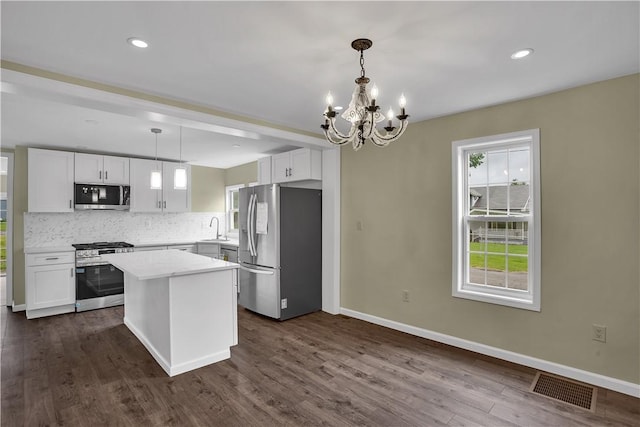 46 Terrace Rd, East Bethlehem, PA 15348 - kitchen with appliances with stainless steel finishes, a sink, a chandelier, tasteful backsplash, and white cabinetry