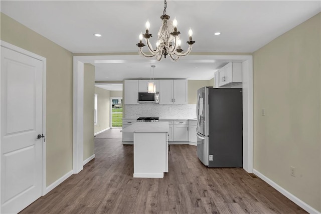 46 Terrace Rd, East Bethlehem, PA 15348 - kitchen featuring appliances with stainless steel finishes, a chandelier, a kitchen island, dark wood-style flooring, and white cabinetry