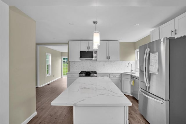 46 Terrace Rd, East Bethlehem, PA 15348 - kitchen with appliances with stainless steel finishes, a sink, a kitchen island, backsplash, and light stone counters